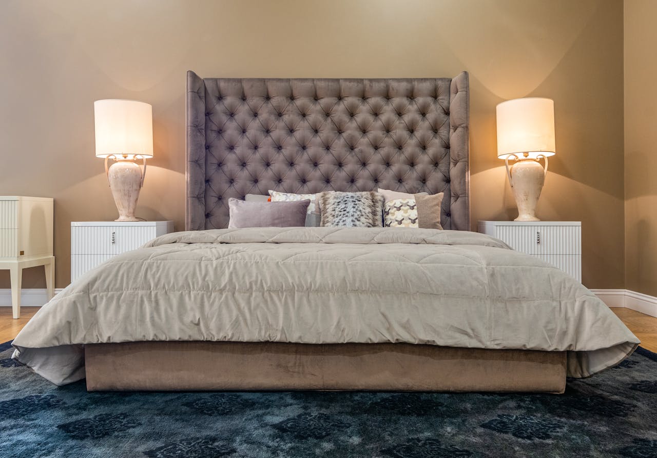 Upscale bedroom with plush bedding and ambient lighting for a cozy and inviting atmosphere.